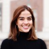 A happy woman in a black turtleneck sweater smiling, representing a satisfied customer who left a positive review for our pressure washing service.